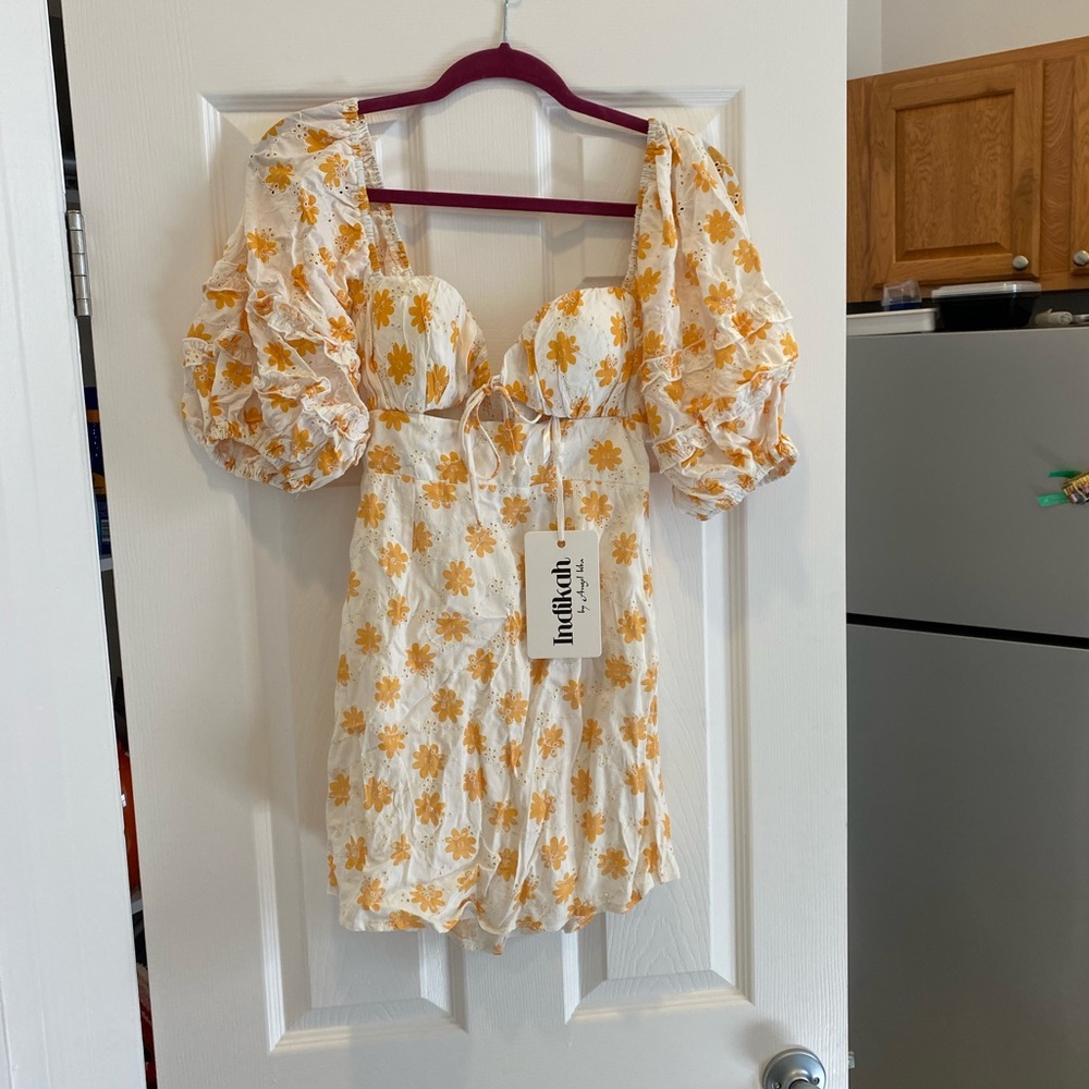 Indikah mini dress. White/yellow floral. Never worn. Runs small.